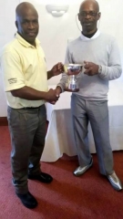 Ian Higgins Winner (left) receiving trophy from last years winner Rhucha Ford