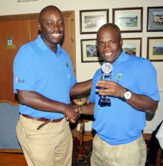 Winner Ian Higgins (right) receiving his award from CGS captain Elford Douglas