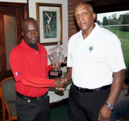 Winner of the Charlie Sifford Memorial Trophy (left)