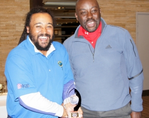 Winner Frank McCook (left) receiving the winner trophy from CGS Captain Elford Douglas